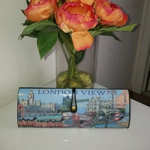 Hard shell graphic blue clutch.